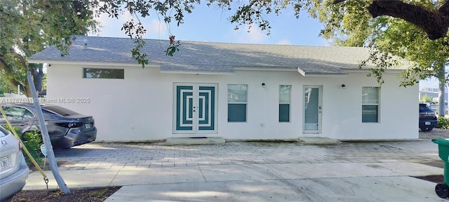 4295 NW 32nd Ave, Miami, FL 33142 - rear view of house with stucco siding and roof with shingles