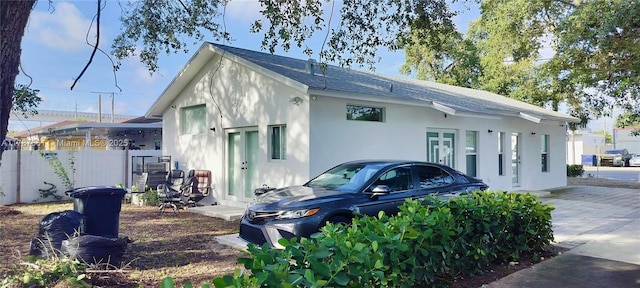 4295 NW 32nd Ave, Miami, FL 33142 - exterior space with roof with shingles, stucco siding, and fence