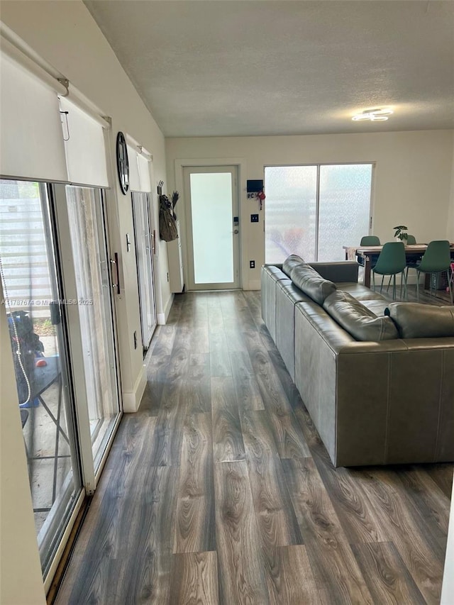 living room featuring baseboards and dark wood-style floors