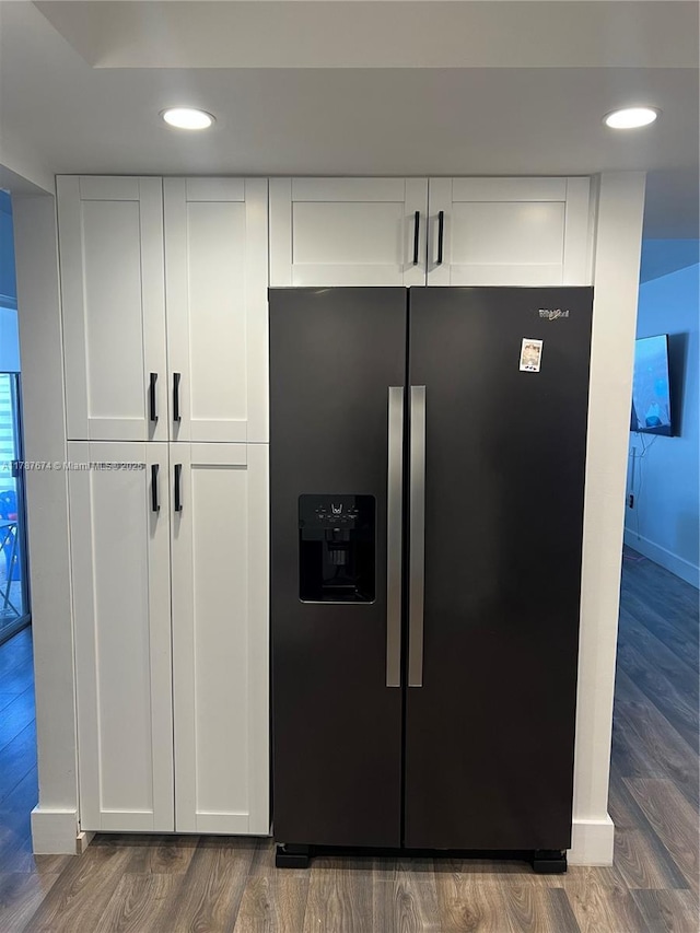 details featuring white cabinetry, wood finished floors, and stainless steel fridge