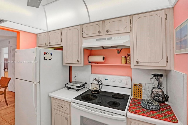 2500 NE 9th St Unit 111, Fort Lauderdale, FL 33304 - kitchen featuring light countertops, light tile patterned floors, under cabinet range hood, and white appliances