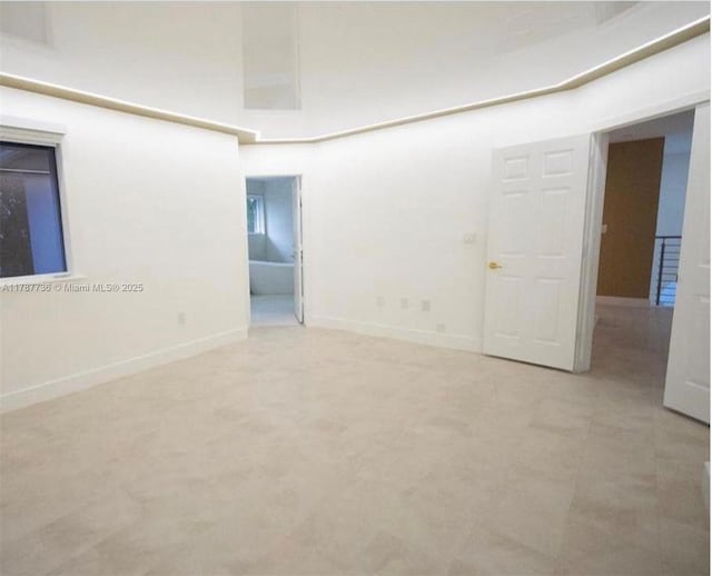 empty room featuring baseboards