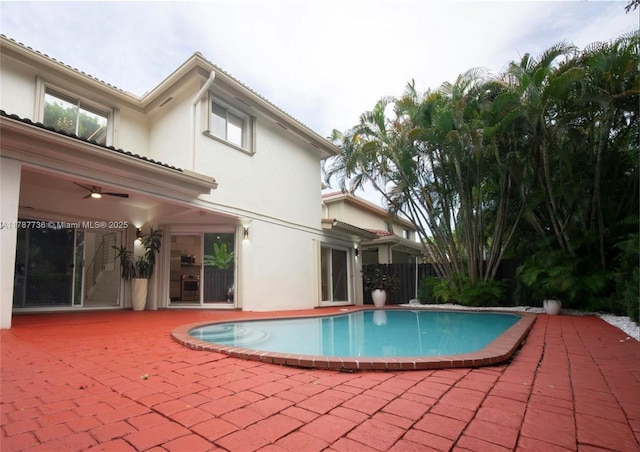 view of pool with a ceiling fan, a fenced in pool, and a patio