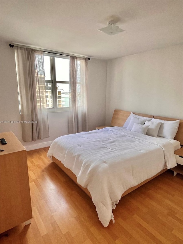 bedroom with light wood finished floors