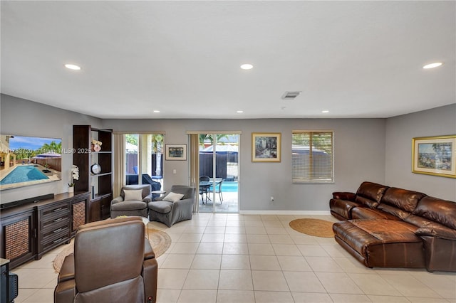 living area featuring recessed lighting, visible vents, baseboards, and light tile patterned floors