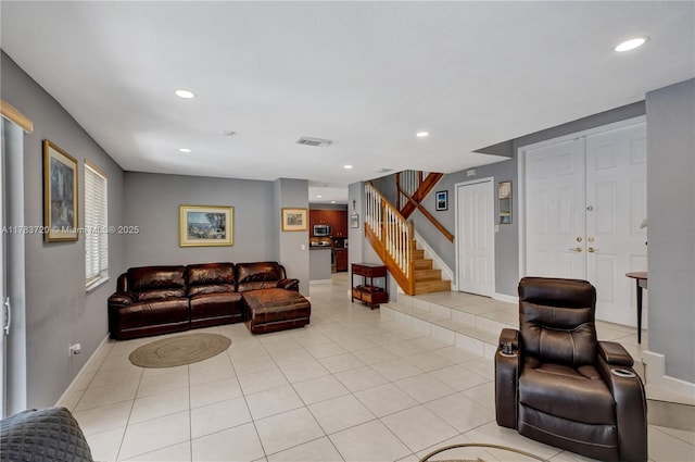 living area featuring recessed lighting, stairway, visible vents, and baseboards