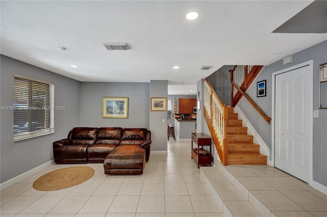 living area featuring recessed lighting, stairway, visible vents, light tile patterned flooring, and baseboards