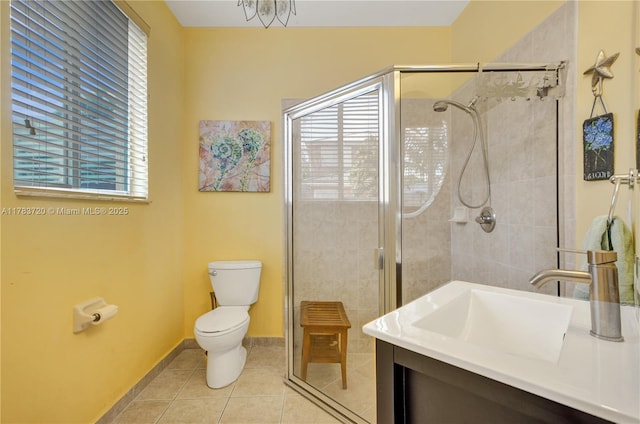 full bath featuring toilet, tile patterned flooring, a shower stall, and a healthy amount of sunlight