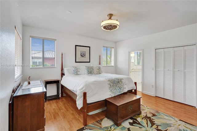 bedroom with connected bathroom and light wood-style floors