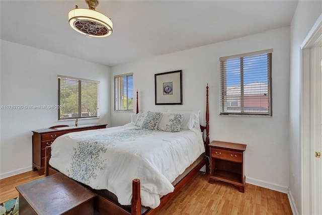 bedroom with light wood-style flooring and baseboards