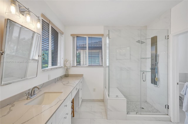 bathroom featuring baseboards, marble finish floor, vanity, and a stall shower