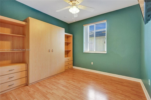 unfurnished bedroom with light wood-type flooring, a closet, and baseboards