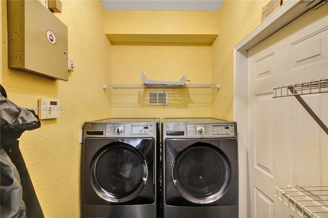 clothes washing area featuring washer and dryer and laundry area