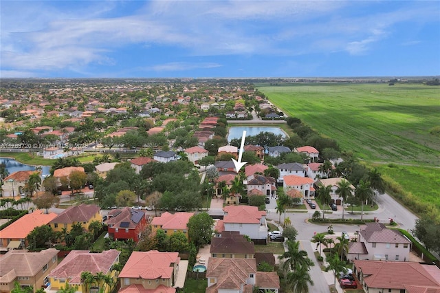drone / aerial view featuring a residential view and a water view