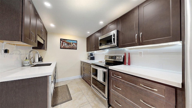11282 SW 9th Ct, Pembroke Pines, FL 33025 - kitchen with appliances with stainless steel finishes, a sink, dark brown cabinets, decorative backsplash, and recessed lighting