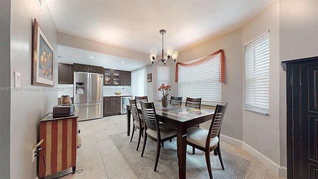 11282 SW 9th Ct, Pembroke Pines, FL 33025 - dining area featuring a chandelier, light tile patterned floors, wine cooler, and baseboards