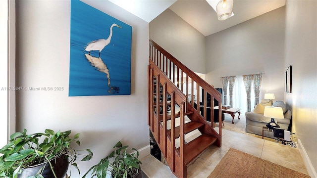 11282 SW 9th Ct, Pembroke Pines, FL 33025 - staircase featuring baseboards, a towering ceiling, and tile patterned floors