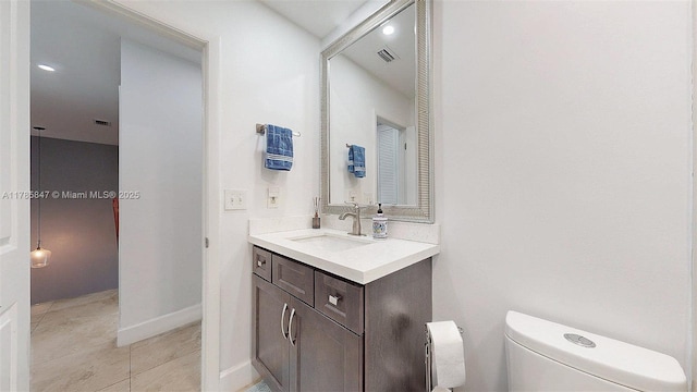 11282 SW 9th Ct, Pembroke Pines, FL 33025 - bathroom with toilet, vanity, and baseboards