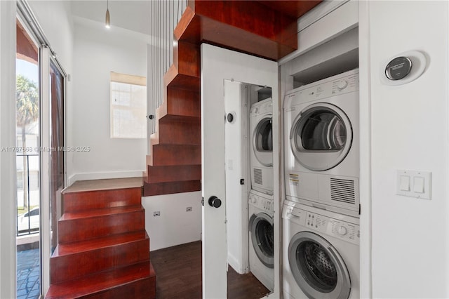 760 Meridian Ave Unit 1, Miami Beach, FL 33139 - clothes washing area featuring stacked washer / drying machine, wood finished floors, baseboards, and laundry area