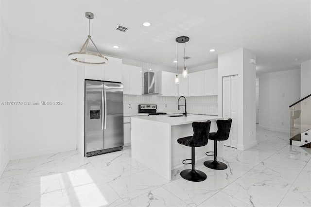 4814 NW 56th Ct, Tamarac, FL 33319 - kitchen featuring stainless steel appliances, wall chimney range hood, modern cabinets, baseboards, and a sink