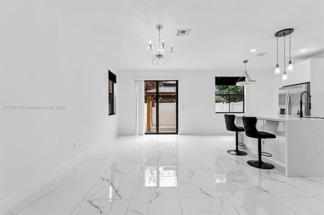 4814 NW 56th Ct, Tamarac, FL 33319 - spare room featuring light marble finish flooring, a chandelier, recessed lighting, and baseboards