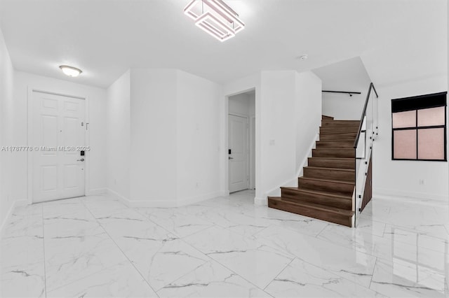 4814 NW 56th Ct, Tamarac, FL 33319 - foyer entrance featuring baseboards, stairway, and marble finish floors