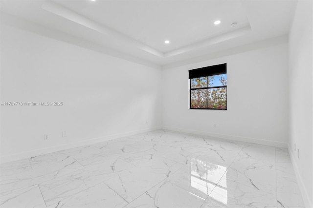 4814 NW 56th Ct, Tamarac, FL 33319 - empty room with a raised ceiling, baseboards, recessed lighting, and light marble finish flooring
