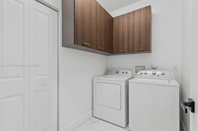 4814 NW 56th Ct, Tamarac, FL 33319 - laundry room with cabinet space, light marble finish flooring, washing machine and clothes dryer, and baseboards