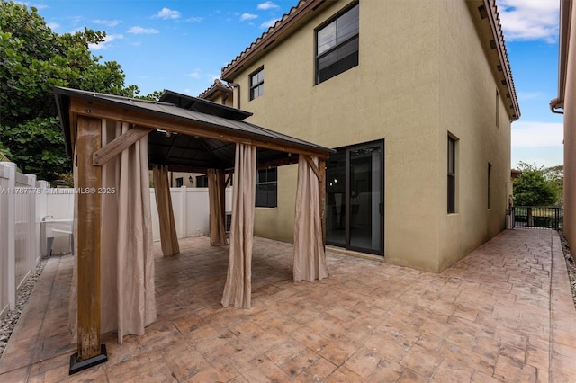 4814 NW 56th Ct, Tamarac, FL 33319 - back of property featuring a gazebo, stucco siding, a patio area, and fence