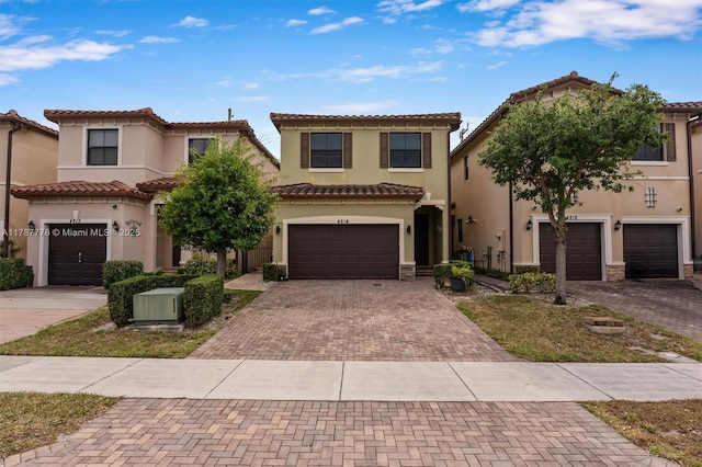 4814 NW 56th Ct, Tamarac, FL 33319 - view of front of house featuring decorative driveway, stucco siding, a tiled roof, and a garage