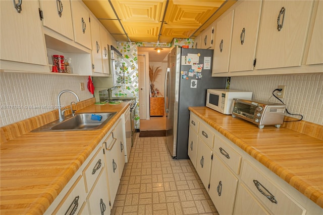 301 174th St Unit 1917, Sunny Isles Beach, FL 33160 - kitchen with tasteful backsplash, open shelves, a sink, brick patterned floor, and white microwave