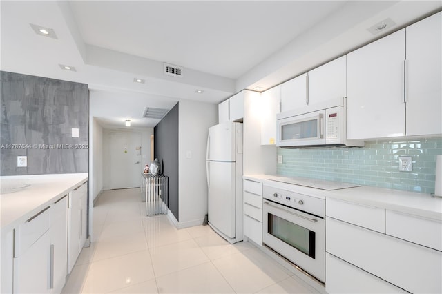 3180 S Ocean Dr Unit 1608, Hallandale Beach, FL 33009 - kitchen featuring white cabinets, recessed lighting, light countertops, white appliances, and decorative backsplash