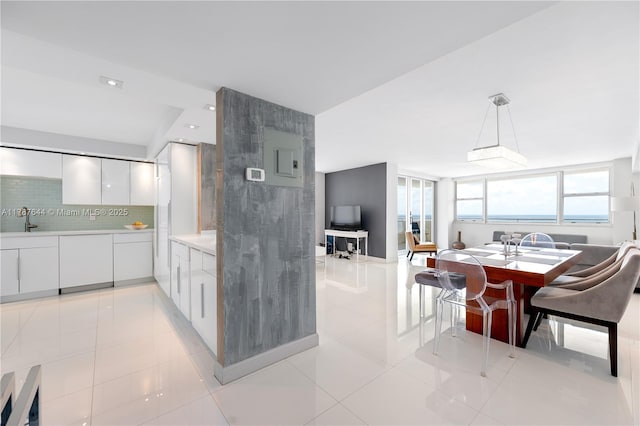 3180 S Ocean Dr Unit 1608, Hallandale Beach, FL 33009 - kitchen featuring white cabinets, a sink, backsplash, modern cabinets, and light countertops