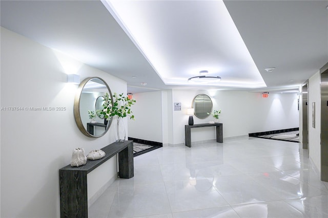 3180 S Ocean Dr Unit 1608, Hallandale Beach, FL 33009 - hall featuring baseboards, a tray ceiling, and tile patterned flooring