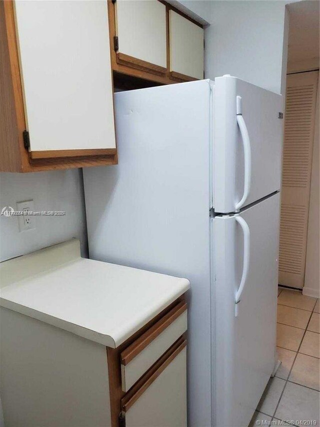 1245 SW 46th Ave Unit 1210, Pompano Beach, FL 33069 - laundry room featuring washing machine and clothes dryer and light tile patterned flooring