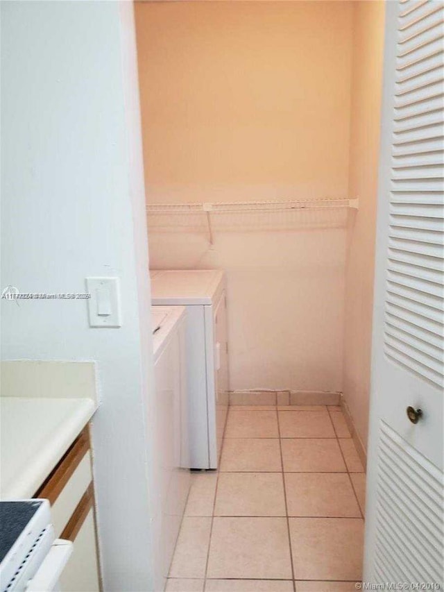 1245 SW 46th Ave Unit 1210, Pompano Beach, FL 33069 - laundry room featuring washing machine and clothes dryer and light tile patterned flooring