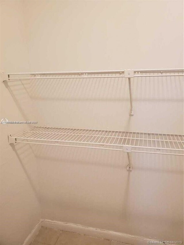 1245 SW 46th Ave Unit 1210, Pompano Beach, FL 33069 - spare room featuring a ceiling fan, light tile patterned floors, and baseboards