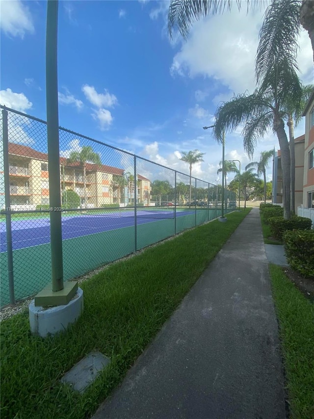 view of tennis court featuring fence
