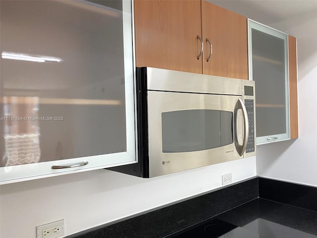18800 NE 29th Ave Unit 1028, Aventura, FL 33180 - interior details with modern cabinets, stainless steel microwave, and glass insert cabinets