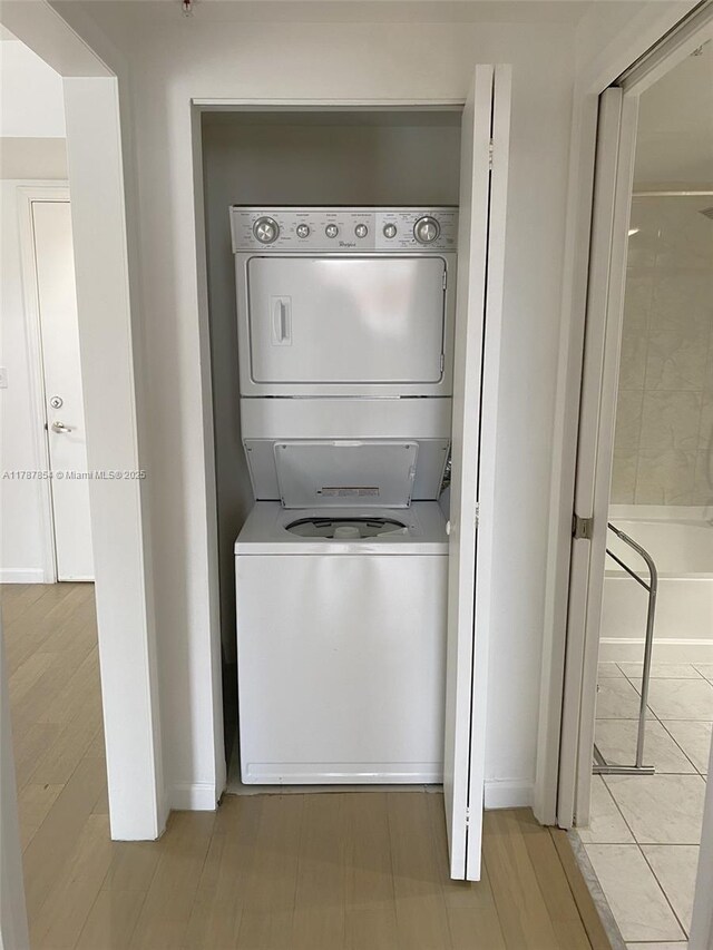 18800 NE 29th Ave Unit 1028, Aventura, FL 33180 - laundry area featuring baseboards, stacked washer and dryer, and laundry area