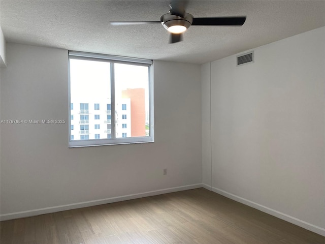 18800 NE 29th Ave Unit 1028, Aventura, FL 33180 - empty room featuring wood finished floors, visible vents, and plenty of natural light