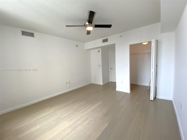 18800 NE 29th Ave Unit 1028, Aventura, FL 33180 - unfurnished bedroom with baseboards, wood finished floors, visible vents, and a closet