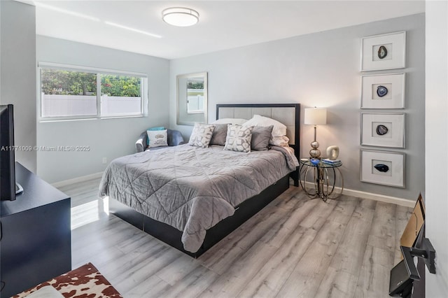 1990 NE 35th St, Lighthouse Point, FL 33064 - bedroom featuring baseboards and wood finished floors