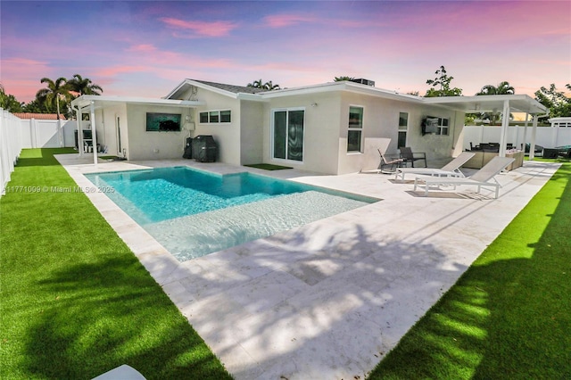 1990 NE 35th St, Lighthouse Point, FL 33064 - rear view of property with a patio area, a lawn, a fenced backyard, a fenced in pool, and stucco siding
