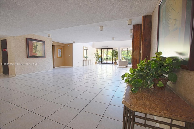 unfurnished room featuring a textured ceiling and light tile patterned floors