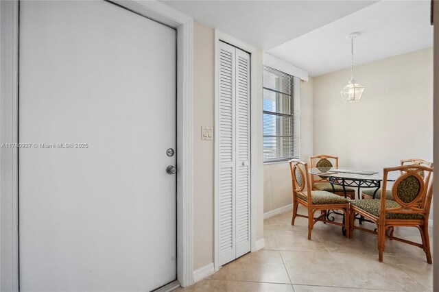 10000 S Ocean Dr Unit 703, Jensen Beach, FL 34957 - dining area featuring light tile patterned flooring and baseboards