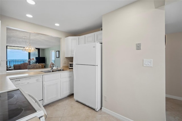 10000 S Ocean Dr Unit 703, Jensen Beach, FL 34957 - kitchen with white appliances, a sink, white cabinetry, light tile patterned flooring, and recessed lighting