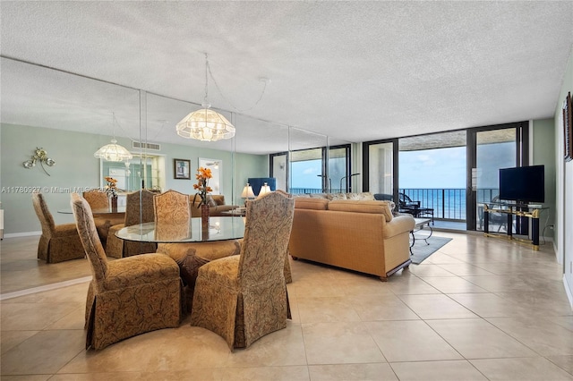 10000 S Ocean Dr Unit 703, Jensen Beach, FL 34957 - dining room featuring a textured ceiling, a wall of windows, and light tile patterned floors