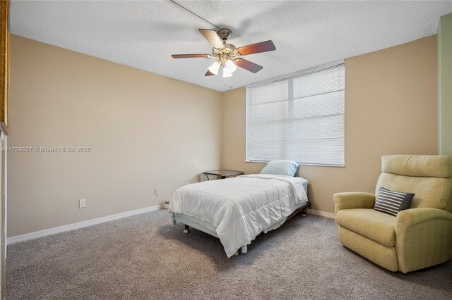 10000 S Ocean Dr Unit 703, Jensen Beach, FL 34957 - carpeted bedroom featuring baseboards, a textured ceiling, and a ceiling fan