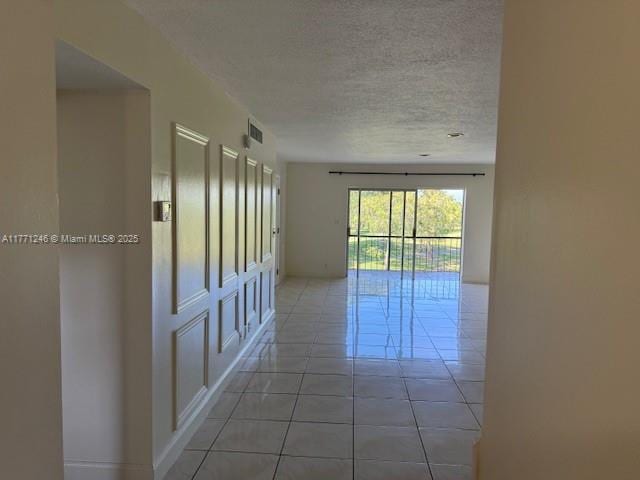 6101 N Falls Circle Dr Unit 312, Lauderhill, FL 33319 - hallway featuring a textured ceiling and light tile patterned floors